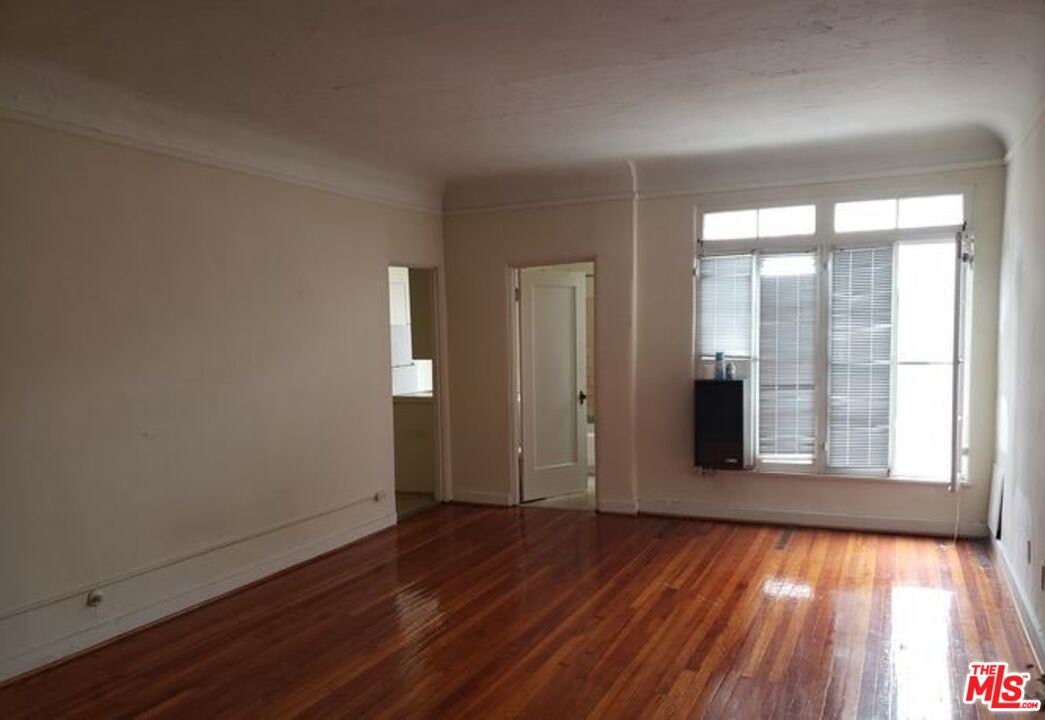 665 South Cochran Avenue, Unit 104 Los Angeles, CA 90036 - Photo 6 of 8 wooden floor in an empty room with a window