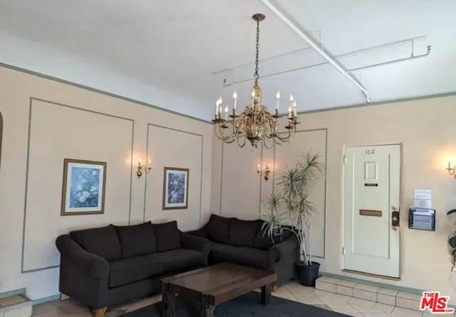 a living room with furniture and a chandelier