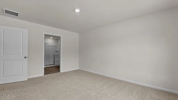a view of an empty room and closet area