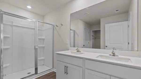 a bathroom with a shower sink and mirror
