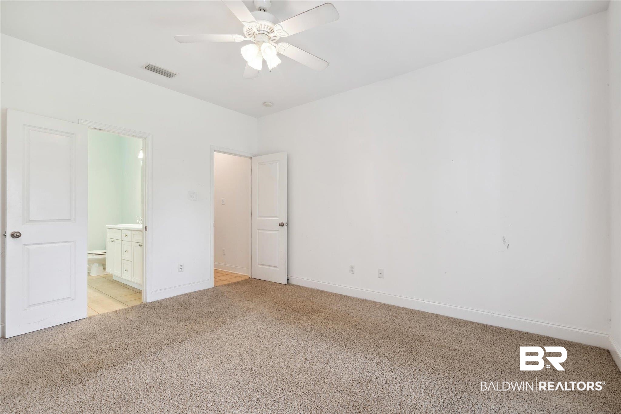 17297 Tallasee Boulevard Foley, AL 36535 - Photo 11 of 24 Unfurnished bedroom featuring ensuite bathroom, ceiling fan, and light colored carpet