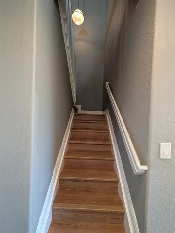 an empty room with wooden floor and closet