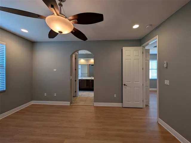 a view of a white house with a yard and potted plants