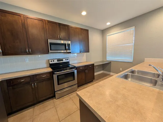 a view of wooden floor in an empty room with a window