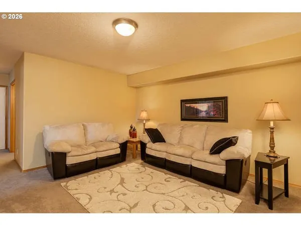 a living room with furniture and a lamp