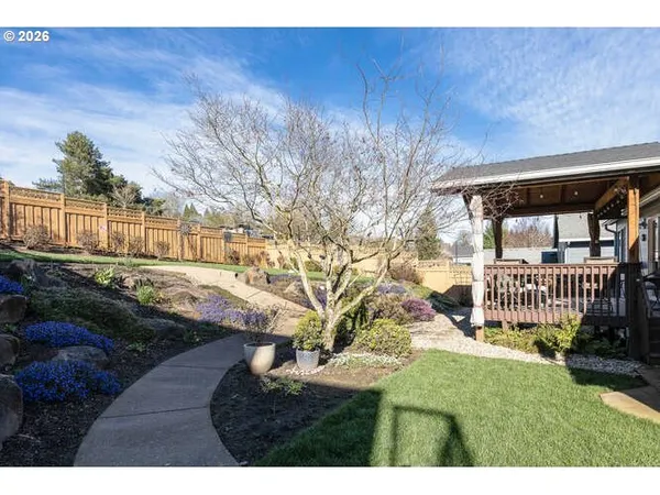 a backyard of a house with table and chairs