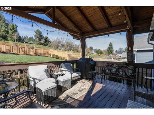 a view of a chairs and table in patio with wooden floor