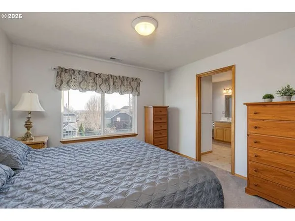 a bedroom with a bed and a dresser