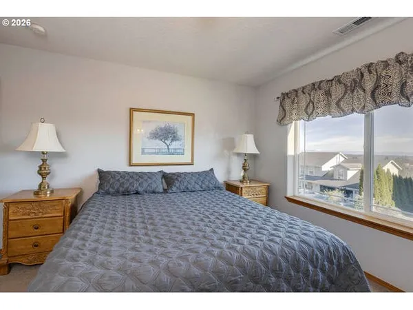 a bedroom with a large bed and a window