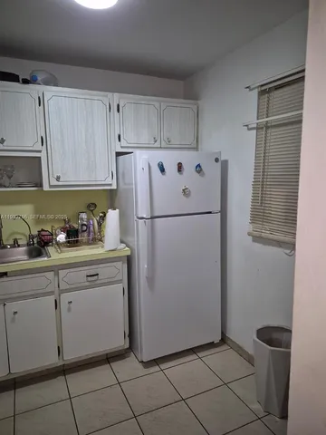 a white refrigerator freezer sitting in a kitchen
