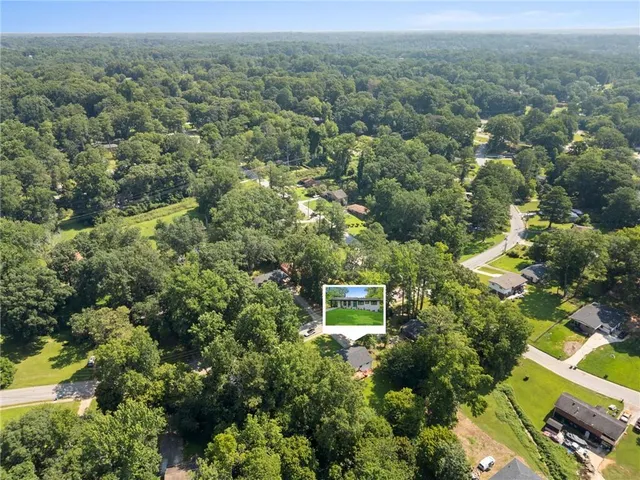 an aerial view of a house with a yard