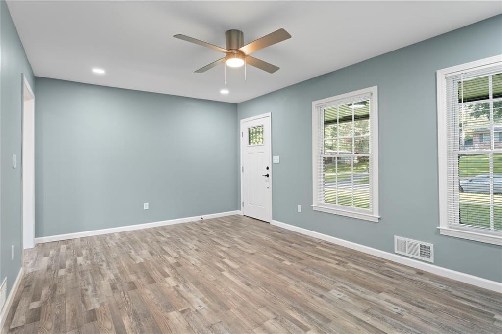 1939 Wee Kirk Road Southeast Atlanta, GA 30316 - Photo 13 of 43 an empty room with wooden floor and windows