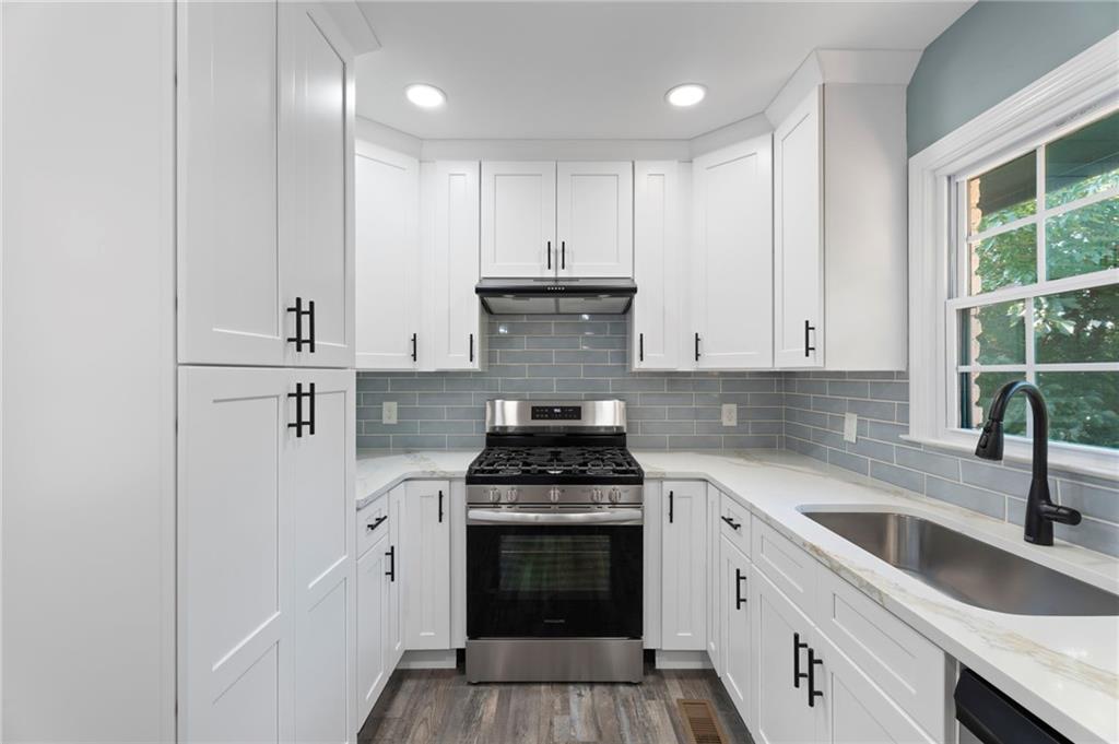 1939 Wee Kirk Road Southeast Atlanta, GA 30316 - Photo 16 of 43 a kitchen with cabinets a sink and appliances