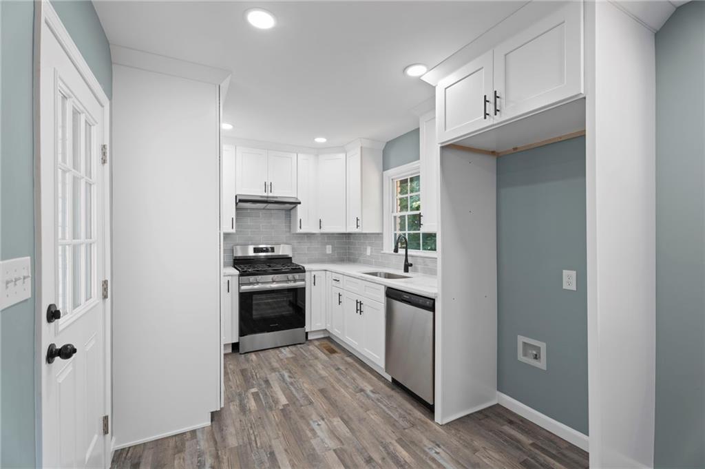 1939 Wee Kirk Road Southeast Atlanta, GA 30316 - Photo 18 of 43 a kitchen with cabinets stainless steel appliances and a window