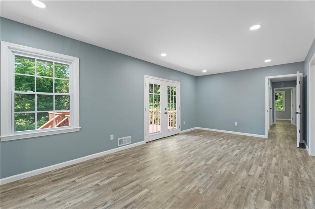1939 Wee Kirk Road Southeast Atlanta, GA 30316 - Photo 20 of 43 a view of an empty room with wooden floor and a window