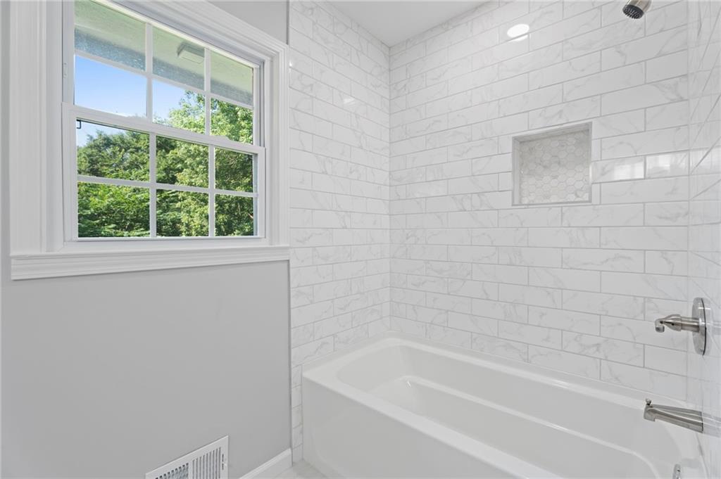 1939 Wee Kirk Road Southeast Atlanta, GA 30316 - Photo 23 of 43 a bathroom with a bathtub