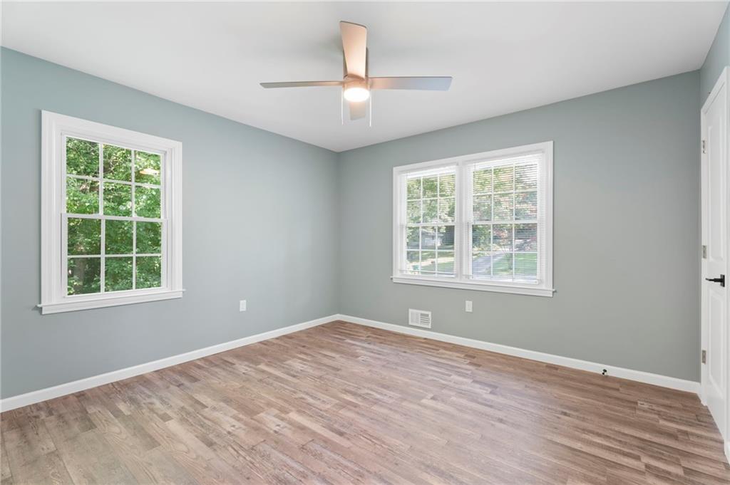 1939 Wee Kirk Road Southeast Atlanta, GA 30316 - Photo 26 of 43 an empty room with wooden floor and windows