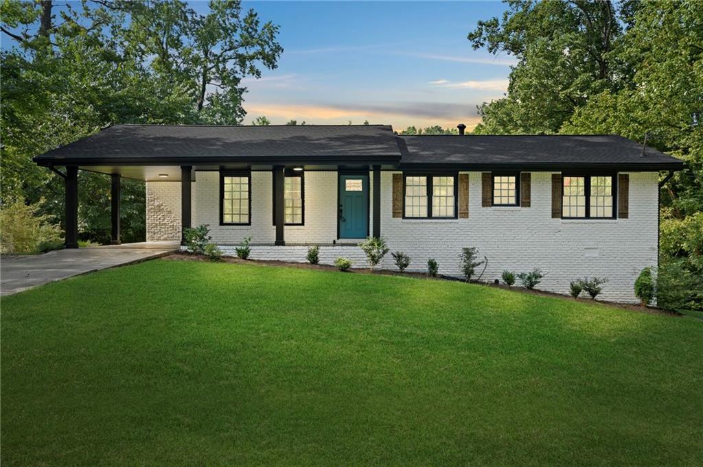 1939 Wee Kirk Road Southeast Atlanta, GA 30316 - Photo 3 of 43 a front view of a house with a yard table and chairs