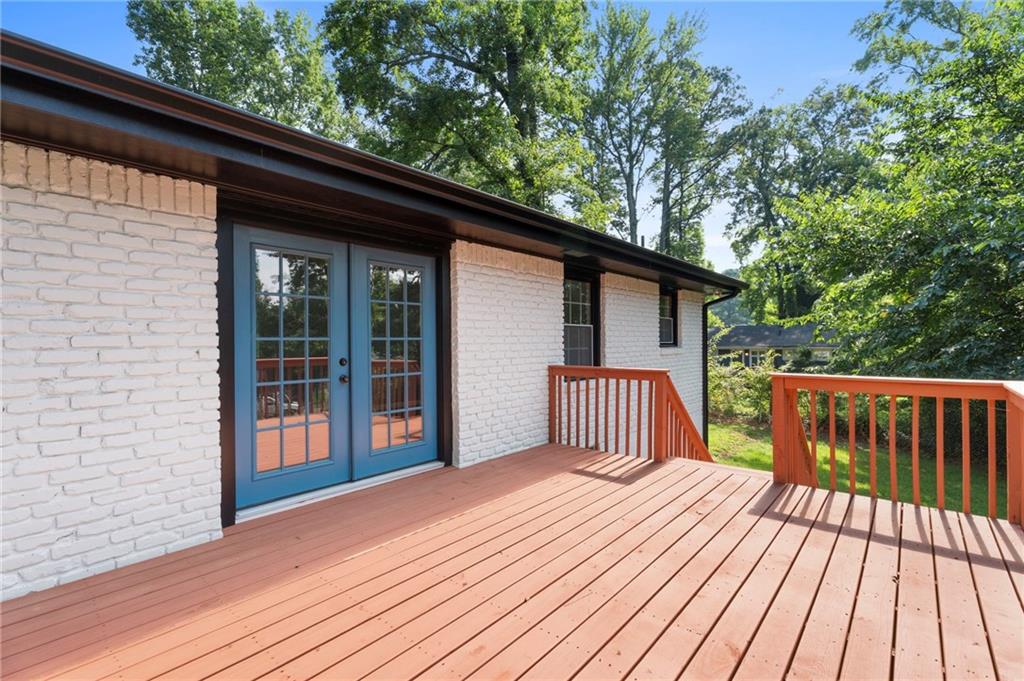 1939 Wee Kirk Road Southeast Atlanta, GA 30316 - Photo 37 of 43 a view of backyard with wooden deck and floor to ceiling window
