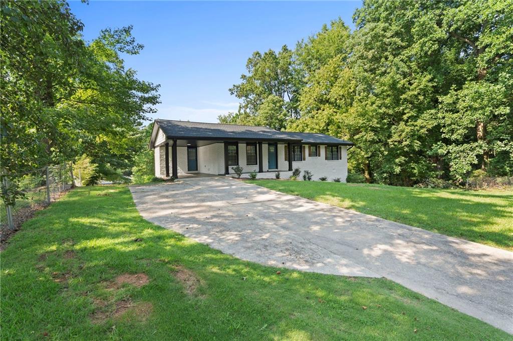 1939 Wee Kirk Road Southeast Atlanta, GA 30316 - Photo 7 of 43 a view of house with backyard and a garden
