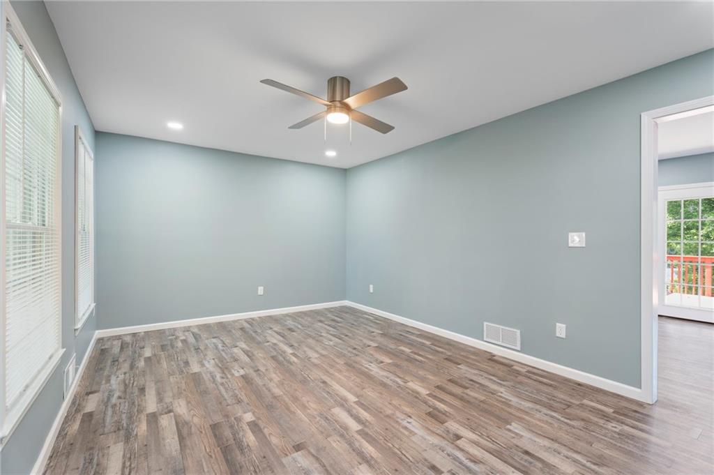 1939 Wee Kirk Road Southeast Atlanta, GA 30316 - Photo 10 of 43 wooden floor in an empty room with a window