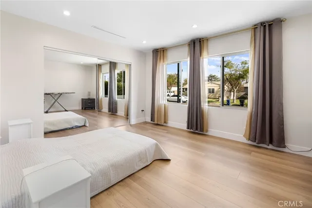 a bedroom with a large bed and a window