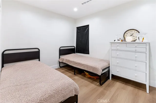 a bedroom with a bed and a dresser