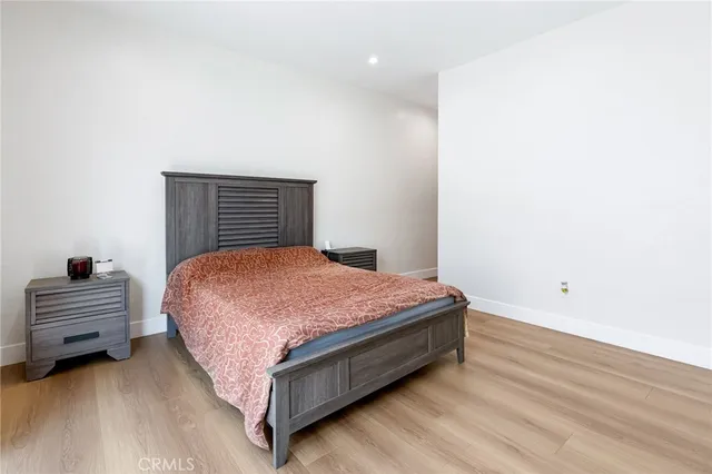 a spacious bedroom with a bed and a dresser