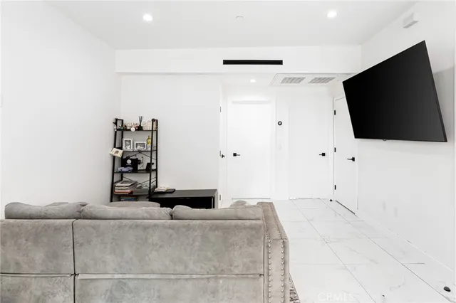 a view of a livingroom with furniture and a flat screen tv