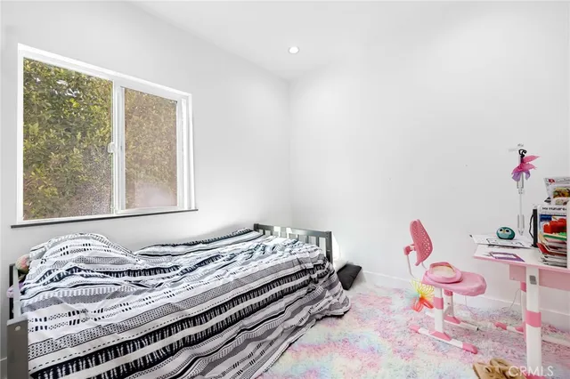a bathroom with a sink vanity mirror and toilet