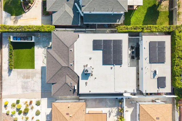 an aerial view of a house with a yard