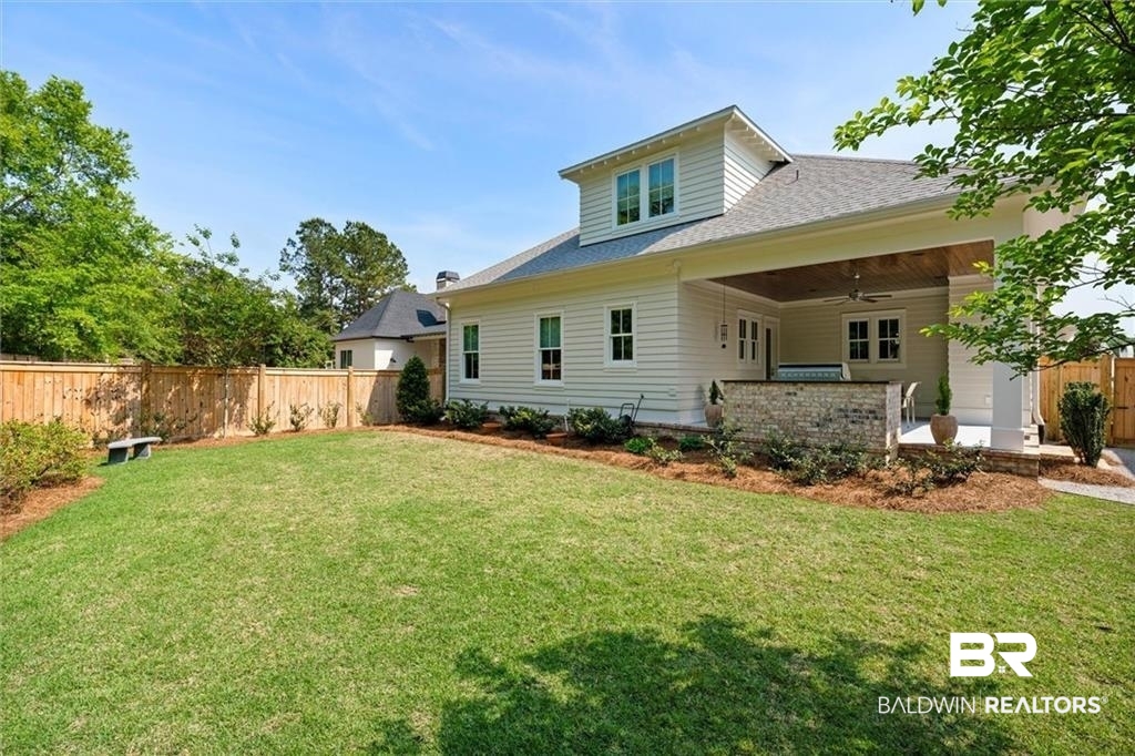 707 Cardamel Court Fairhope, AL 36532 - Photo 37 of 40 Back of house featuring a patio, a yard, and ceiling fan