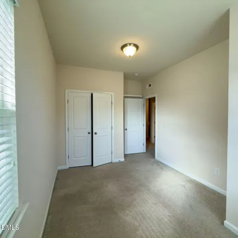 a view of an empty room and a window