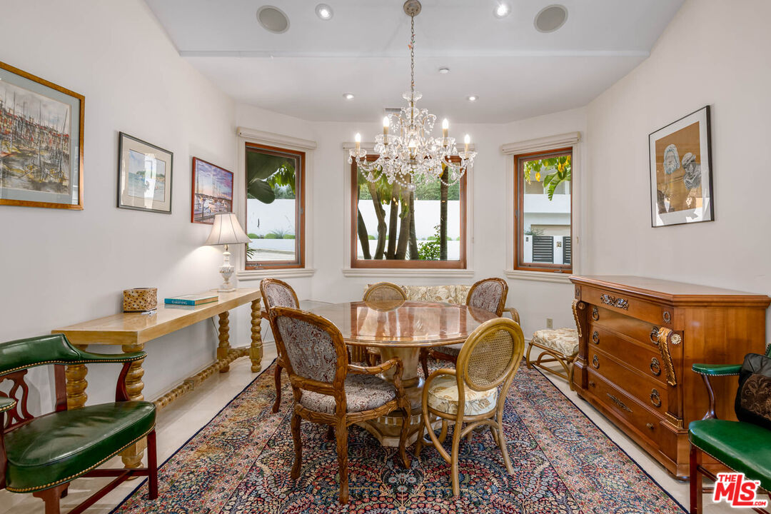936 Kenfield Avenue Los Angeles, CA 90049 - Photo 11 of 30 a dining room with furniture a chandelier and window