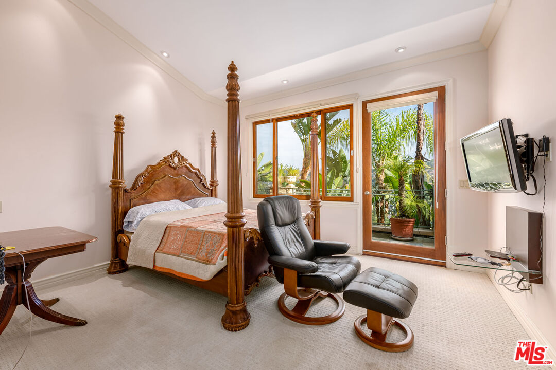 936 Kenfield Avenue Los Angeles, CA 90049 - Photo 12 of 30 a bedroom with furniture and a flat screen tv