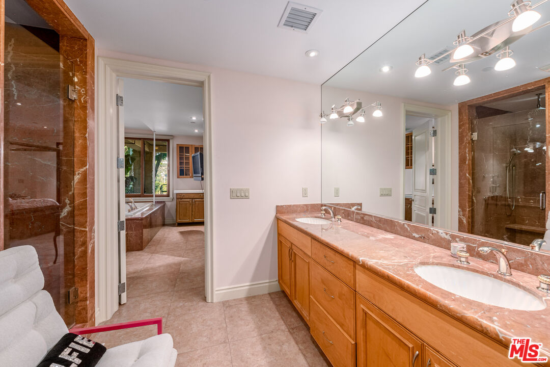 936 Kenfield Avenue Los Angeles, CA 90049 - Photo 20 of 30 a bathroom with a sink and a mirror