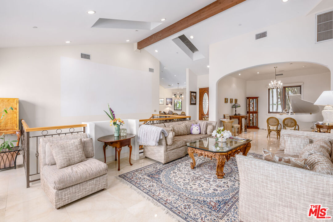 936 Kenfield Avenue Los Angeles, CA 90049 - Photo 5 of 30 a living room with fireplace furniture and a rug