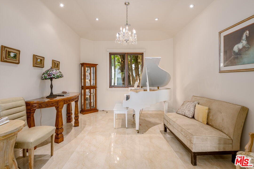 936 Kenfield Avenue Los Angeles, CA 90049 - Photo 6 of 30 a living room with furniture and a chandelier