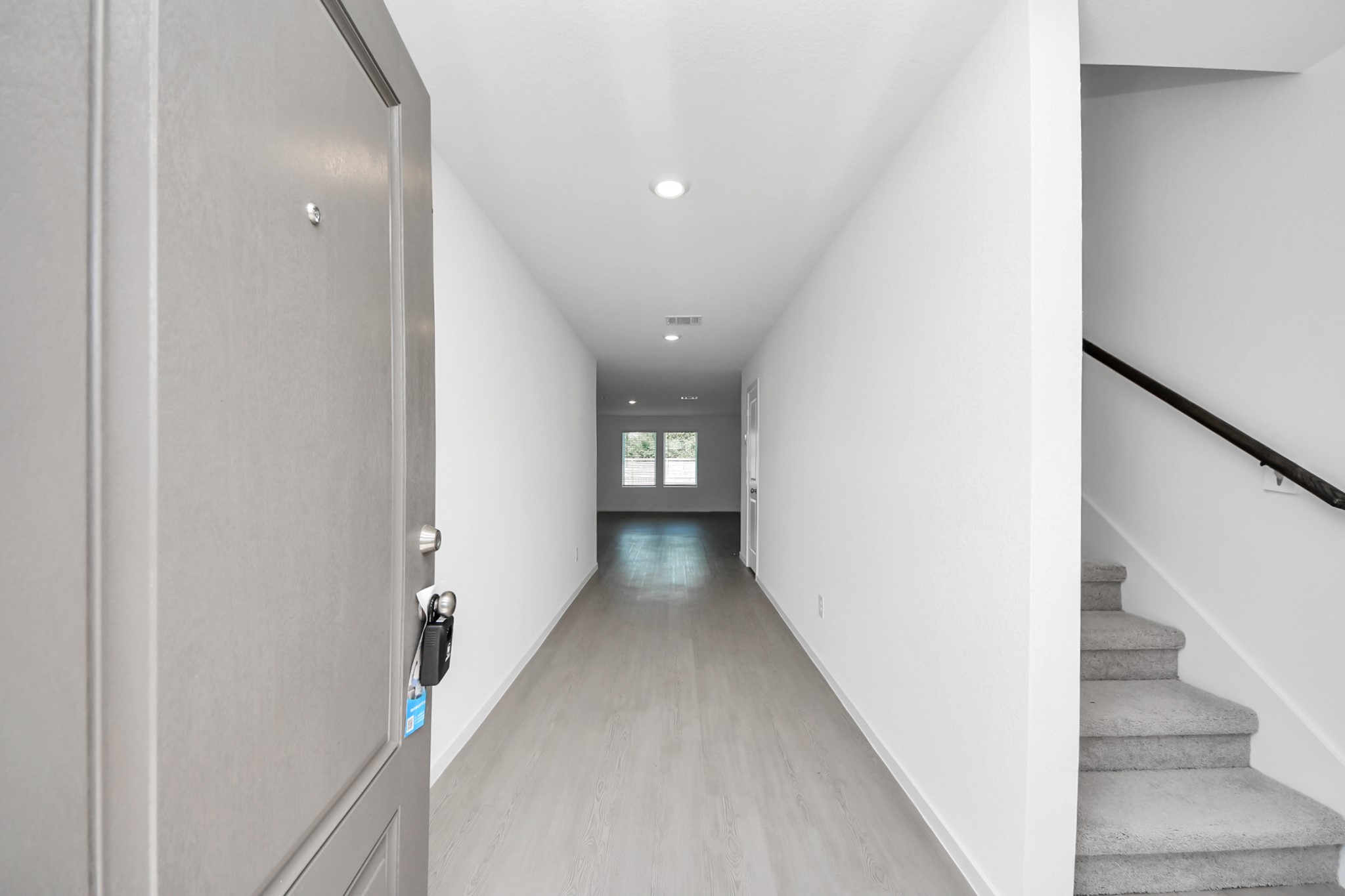 2931 Summer Breeze Way Angleton, TX 77515 - Photo 3 of 30 a view of a hallway with wooden floor and staircase