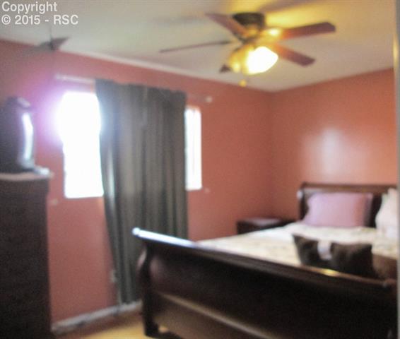 3880 Half Turn Road Colorado Springs, CO 80917 - Photo 6 of 11 Upper level master bedroom with hardwood flooring & ceiling fan