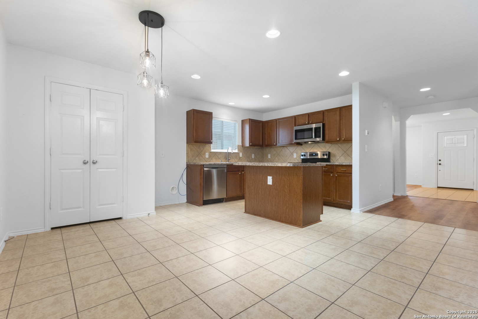 9418 Madison Creek Converse, TX 78109 - Photo 5 of 31 a kitchen with stainless steel appliances granite countertop a refrigerator and a sink