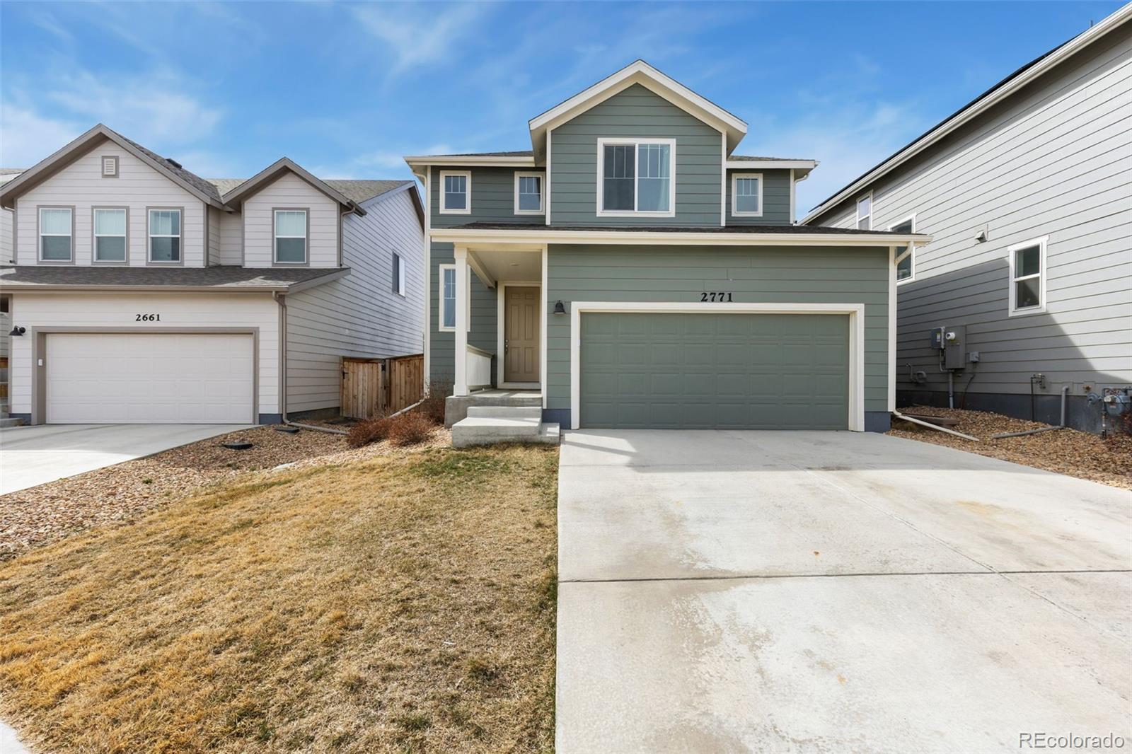 2771 Big Empty Place Berthoud, CO 80513 - Photo 2 of 25 a front view of a house with a yard and garage