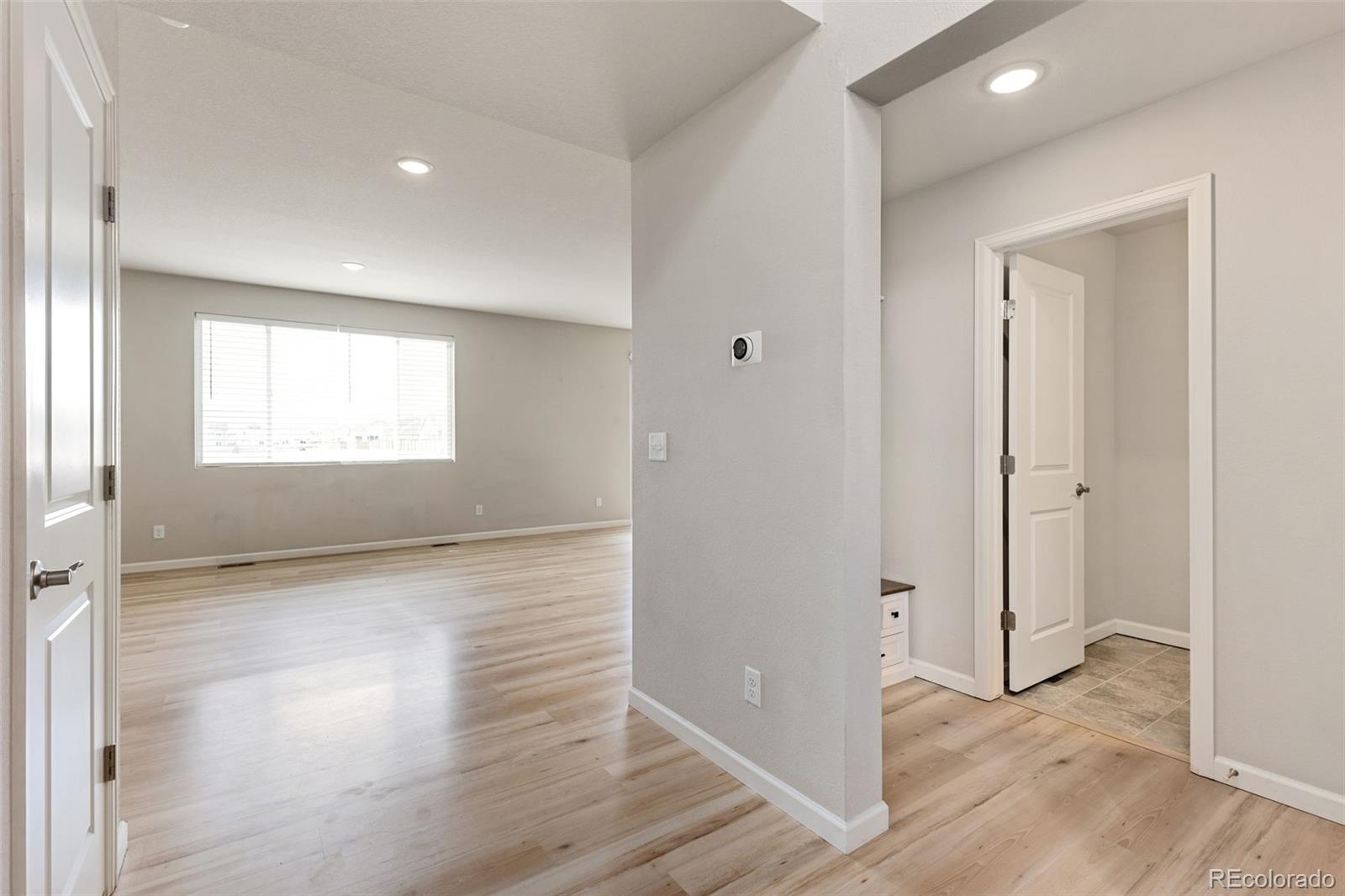2771 Big Empty Place Berthoud, CO 80513 - Photo 3 of 25 a view of an empty room with wooden floor and a window