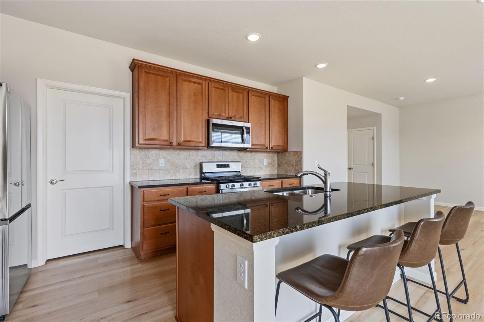 2771 Big Empty Place Berthoud, CO 80513 - Photo 10 of 25 a kitchen with kitchen island granite countertop a sink and counter space