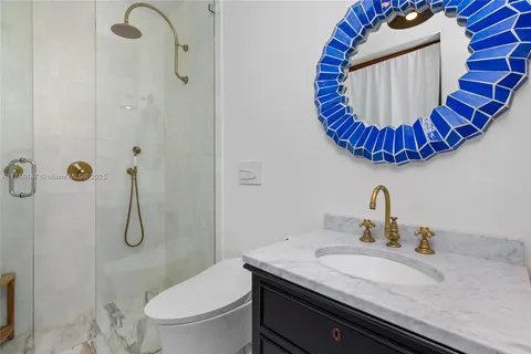 a bathroom with a sink a toilet and shower curtain