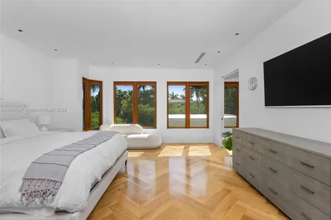 a spacious bedroom with a large bed and a flat screen tv