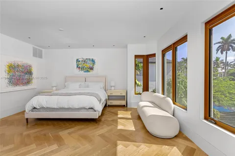 a spacious bedroom with a bed and a large window