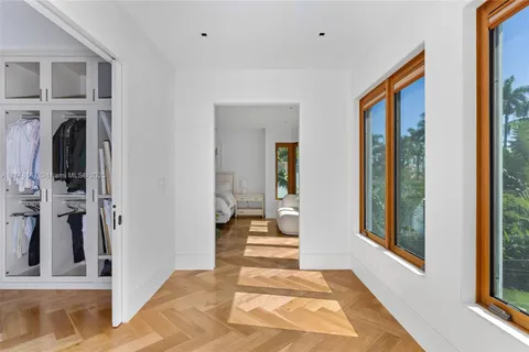 a view of a hallway to a livingroom with furniture