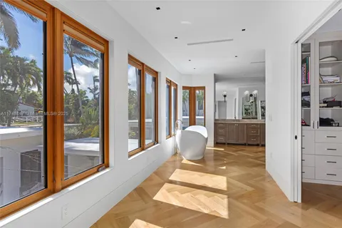 a living room with furniture a rug and a large window