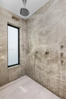 a bathroom with a shower and a sink